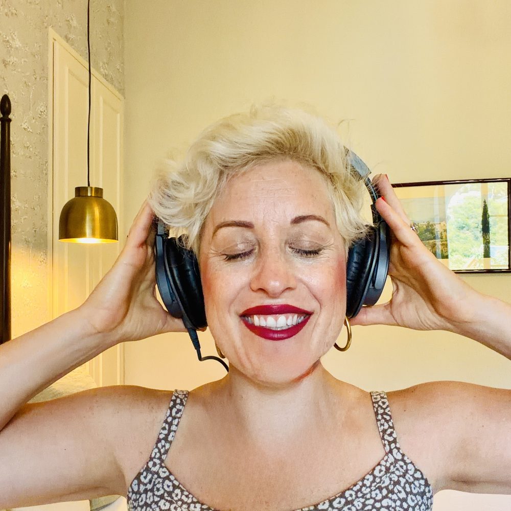 Carli smiling with headphones on